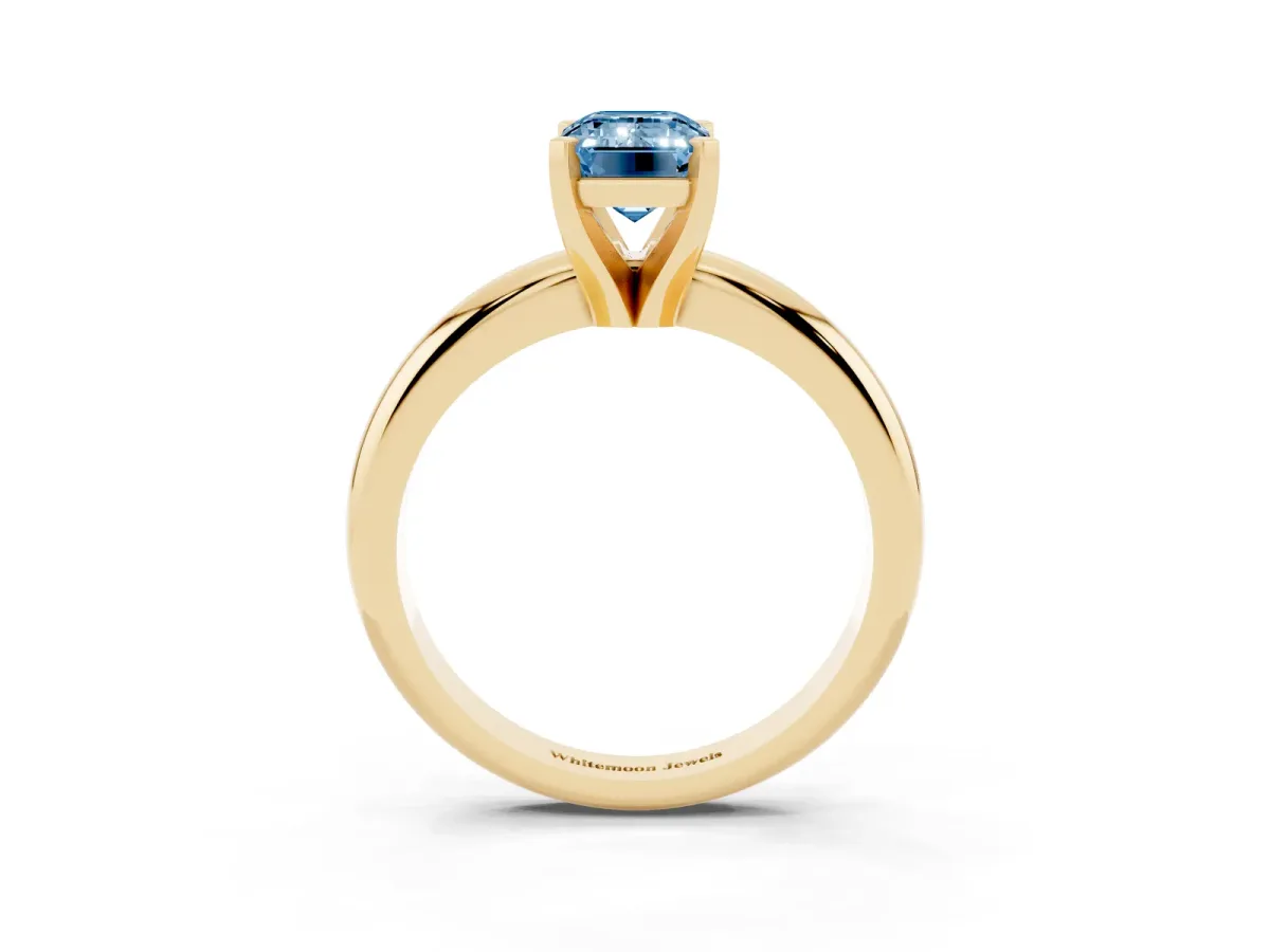 Fancy Blue Emerald Cut Diamond Solitaire Engagement Ring with Round Band and Four-Prong Setting Yellow gold