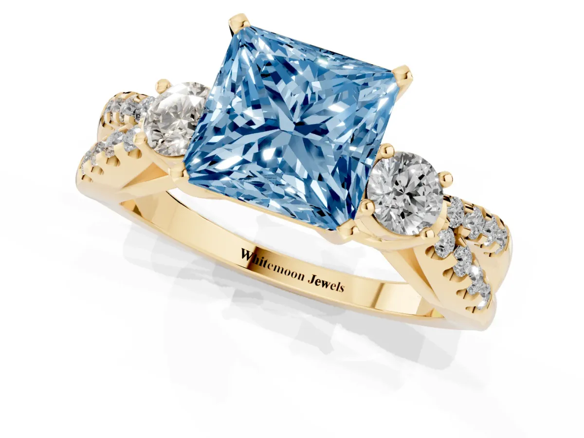 Fancy Blue Princess Cut Diamond Three-Stone Ring with Pavé Split Shank and Four-Prong Setting Yellow gold