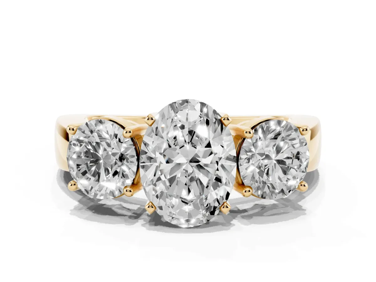 Three-Stone Oval Cut Diamond Ring with Round Side Stones, Classic Band, and Four-Prong Setting Yellow gold