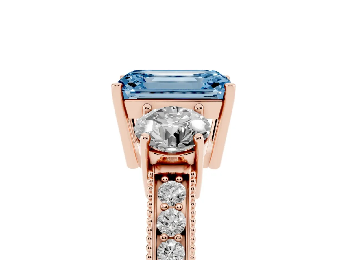 Fancy Blue Emerald Cut Three-Stone Diamond Ring with Pavé Band and Four-Prong Setting Rose gold