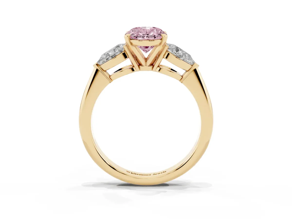Fancy Pink Three-Stone Oval Cut Diamond Ring with Pear Side Stones and Four-Prong Setting Yellow gold