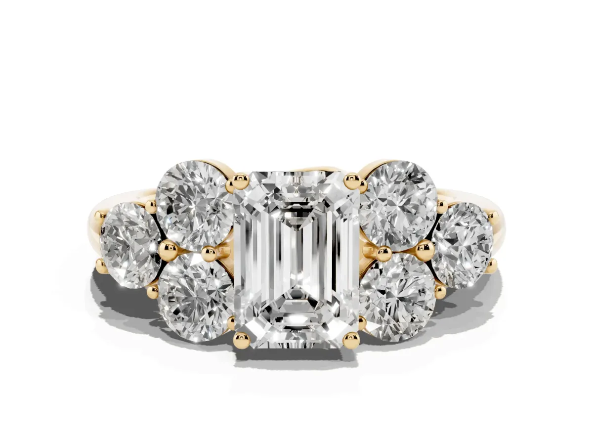 Emerald Cut Cut Diamond Cluster Ring with Round Accent Stones and Prong Setting on a Classic Band Yellow gold