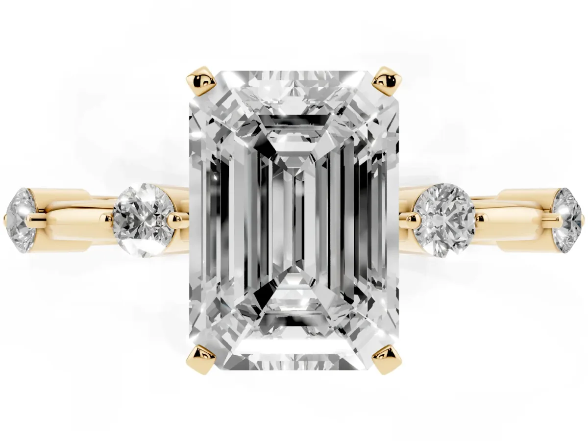 Emerald Cut Solitaire Diamond Ring with Bezel Set Side Stones and Prong Setting Yellow gold