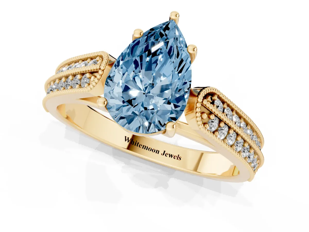 Fancy Blue Pear Cut Cut Pave Split Shank Engagement Ring with Four-Prong Setting Yellow gold