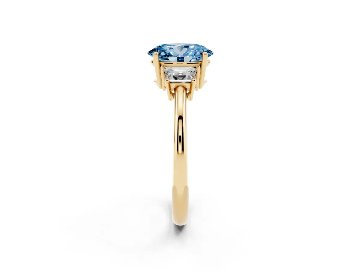 Fancy Blue Oval Cut Diamond Three-Stone Ring with Trapezoid Side Stones and Prong Setting Yellow gold
