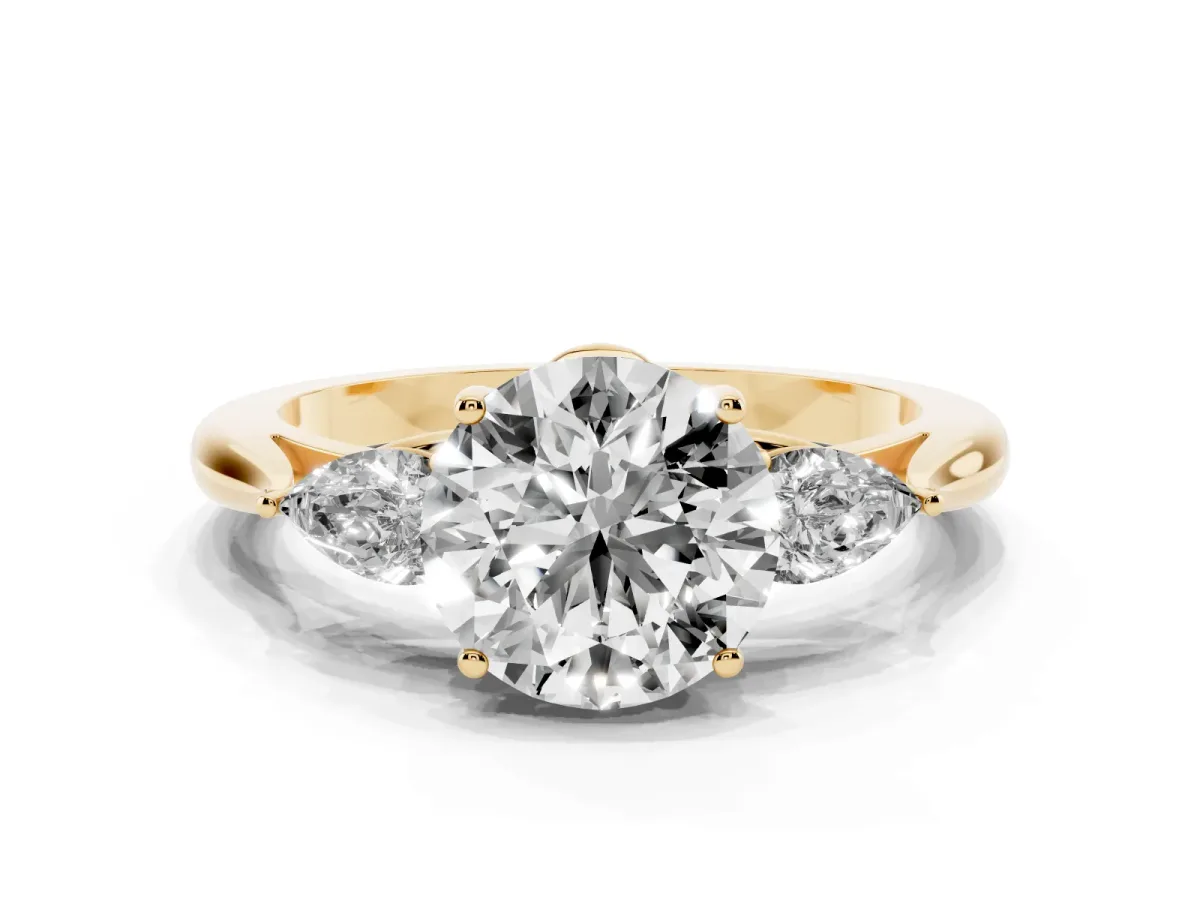 Three-Stone Round Cut Diamond Ring with Pear Side Stones in Four-Prong Setting Yellow gold
