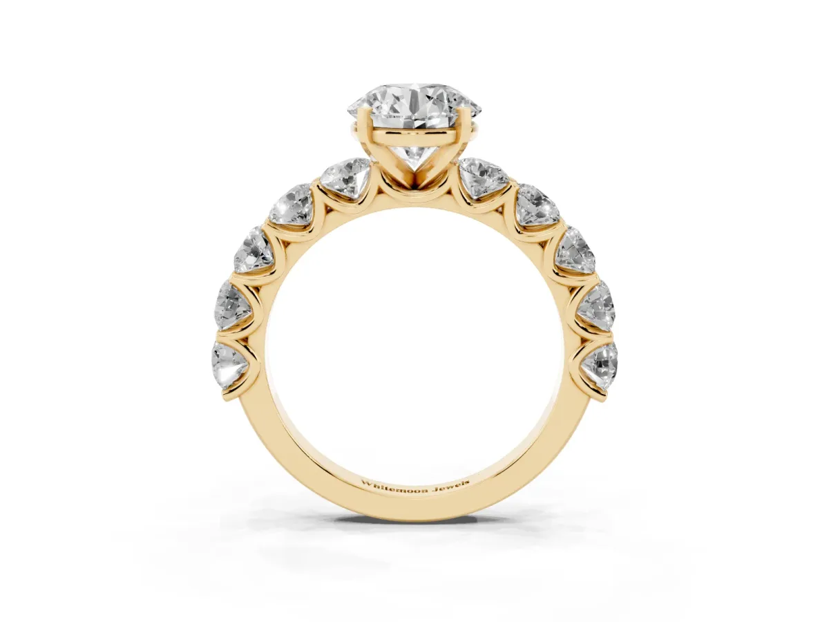 Round Cut Diamond Prong Setting with Side Stones on a Pave Band Yellow gold