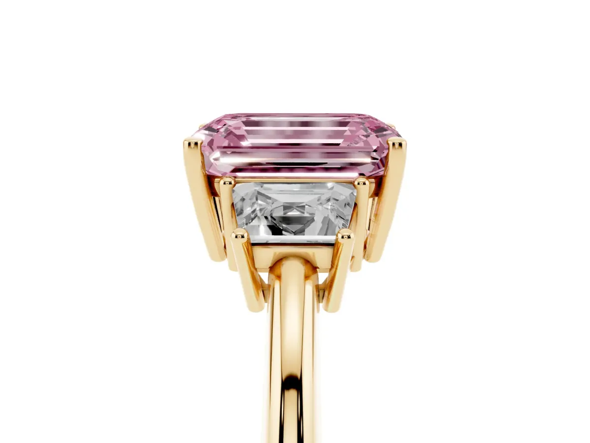 Fancy Pink Emerald Cut Diamond Three-Stone Ring with Trapezoid Side Stones and Prong Setting Yellow gold