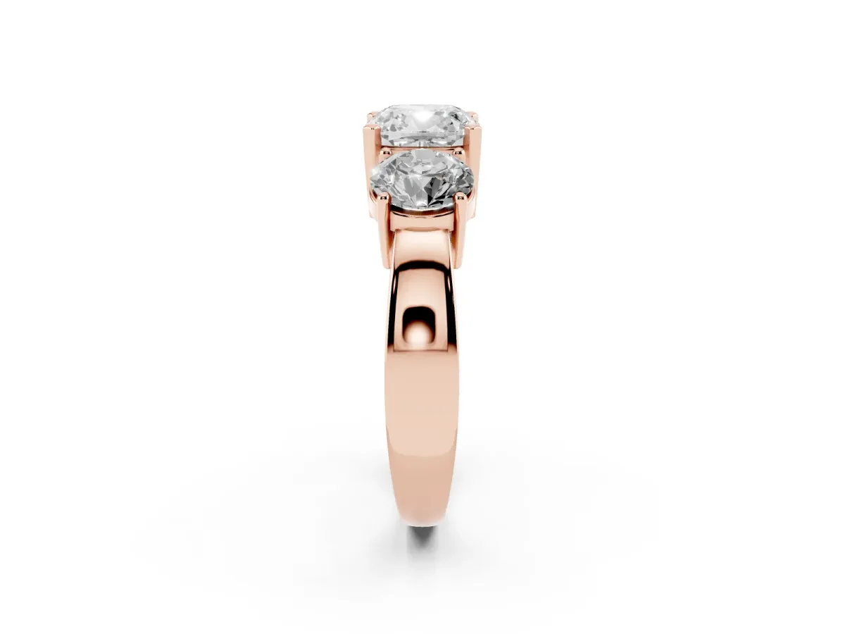Three-Stone Cushion Cut Diamond Ring with Round Side Stones, Classic Band, and Four-Prong Setting Rose gold