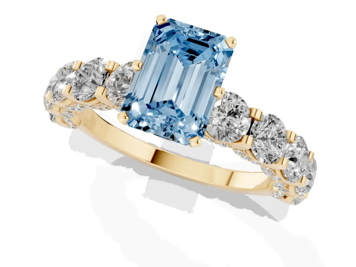 Fancy Blue Emerald Cut Diamond Side Stone Engagement Ring with Four-Prong Setting Yellow gold