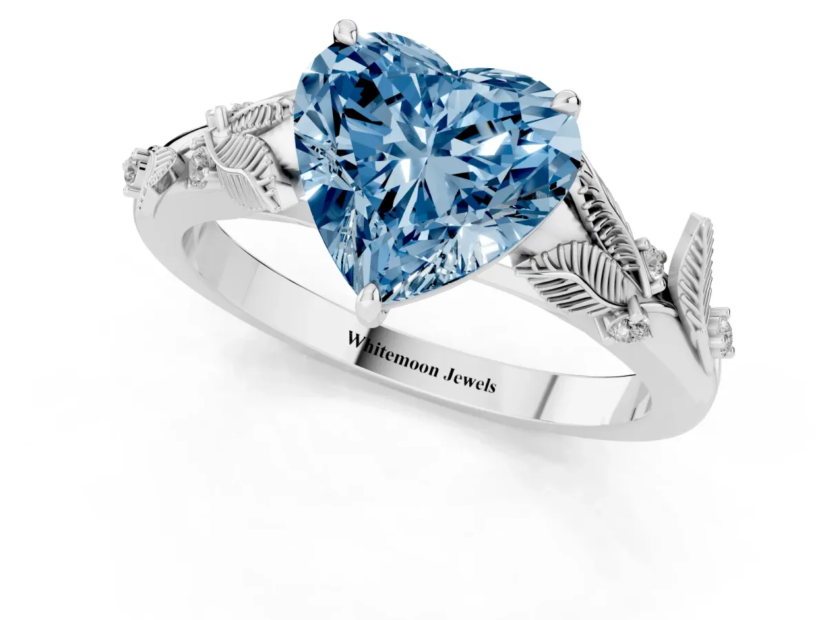 Fancy Blue Heart Cut Diamond Solitaire Ring with Leaf Motif Band and Four-Prong Setting Platinum