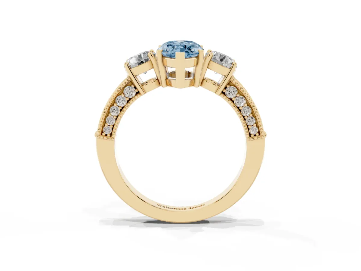 Fancy Blue Marquise Cut Three-Stone Diamond Ring with Pavé Band and Four-Prong Setting Yellow gold