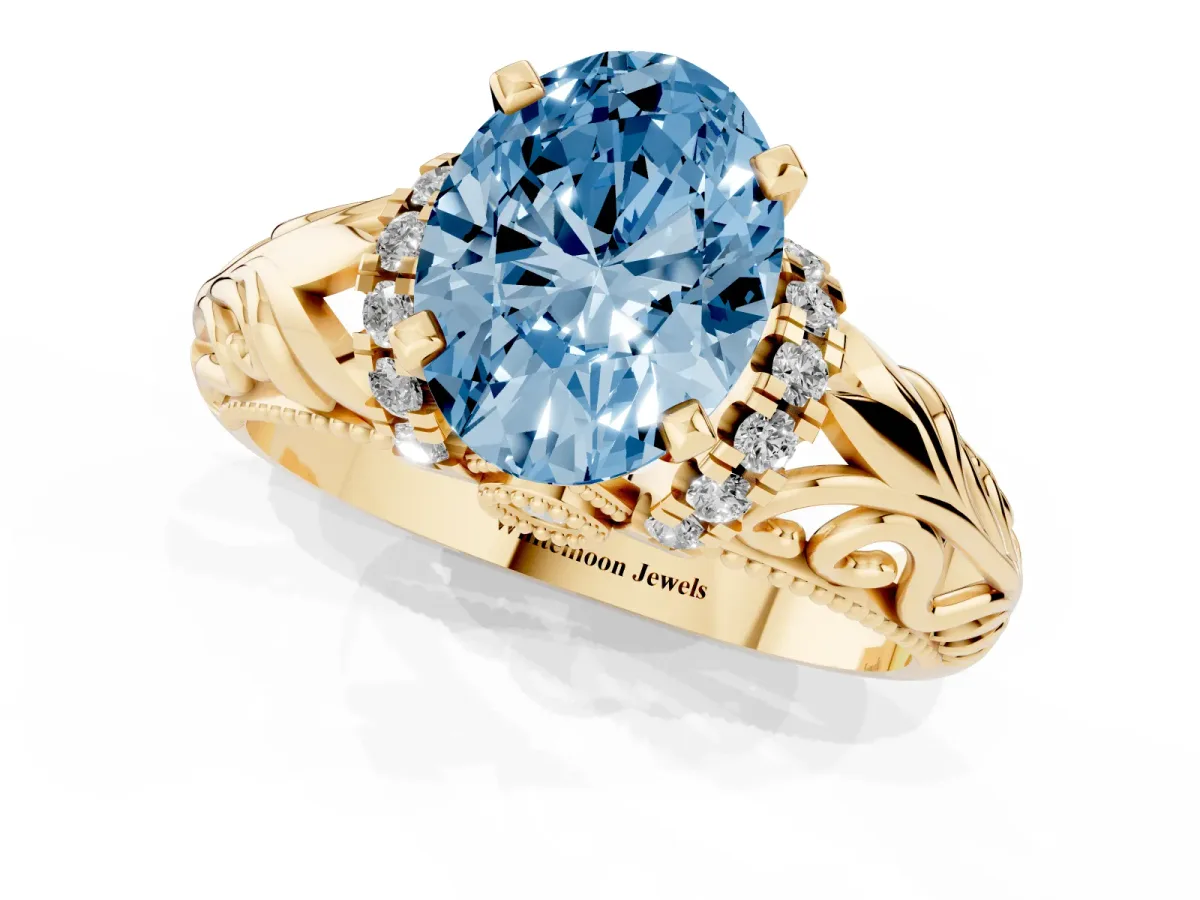 Fancy Blue Oval Cut Solitaire Filigree Engagement Ring with Halo and Prong Setting Yellow gold