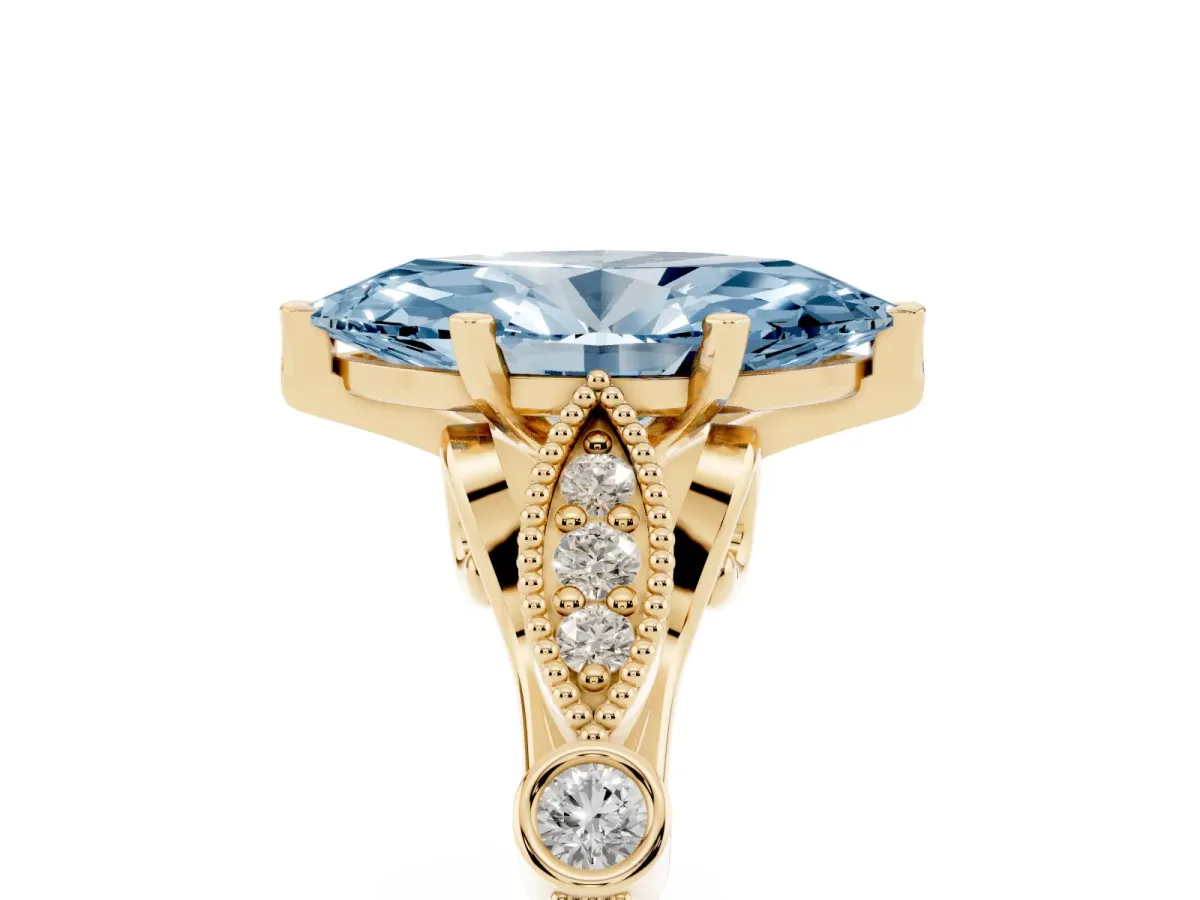 Fancy Blue Marquise Cut Cut Diamond with Milgrain Marquise and Bezel Accents on a Solitaire Band with Prong Setting Yellow gold