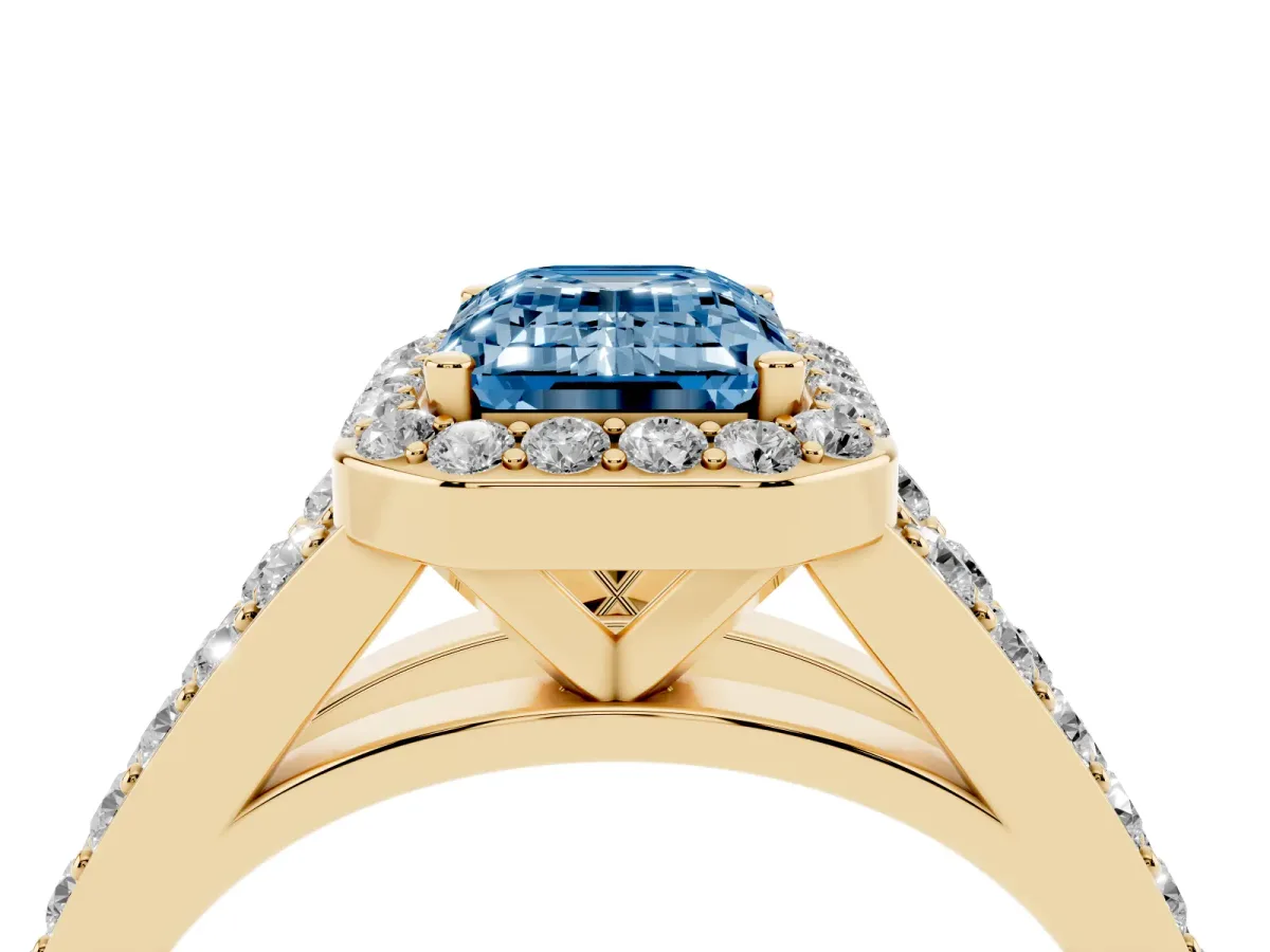 Fancy Blue Emerald Cut Diamond Split Shank Halo Ring with Four-Prong Setting Yellow gold