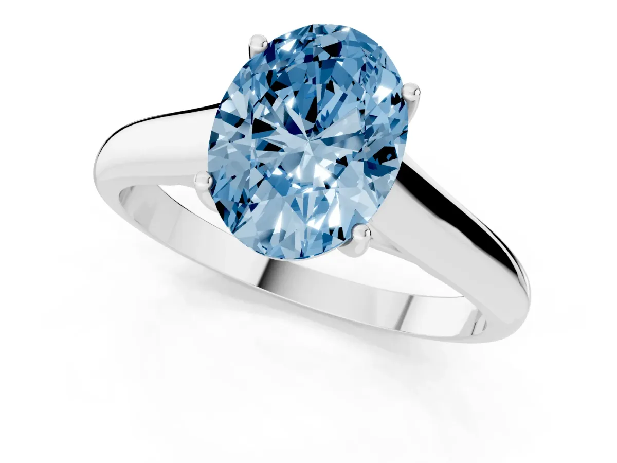 Fancy Blue Oval Cut Solitaire Engagement Ring with Tapered Band and Four-Prong Setting Silver