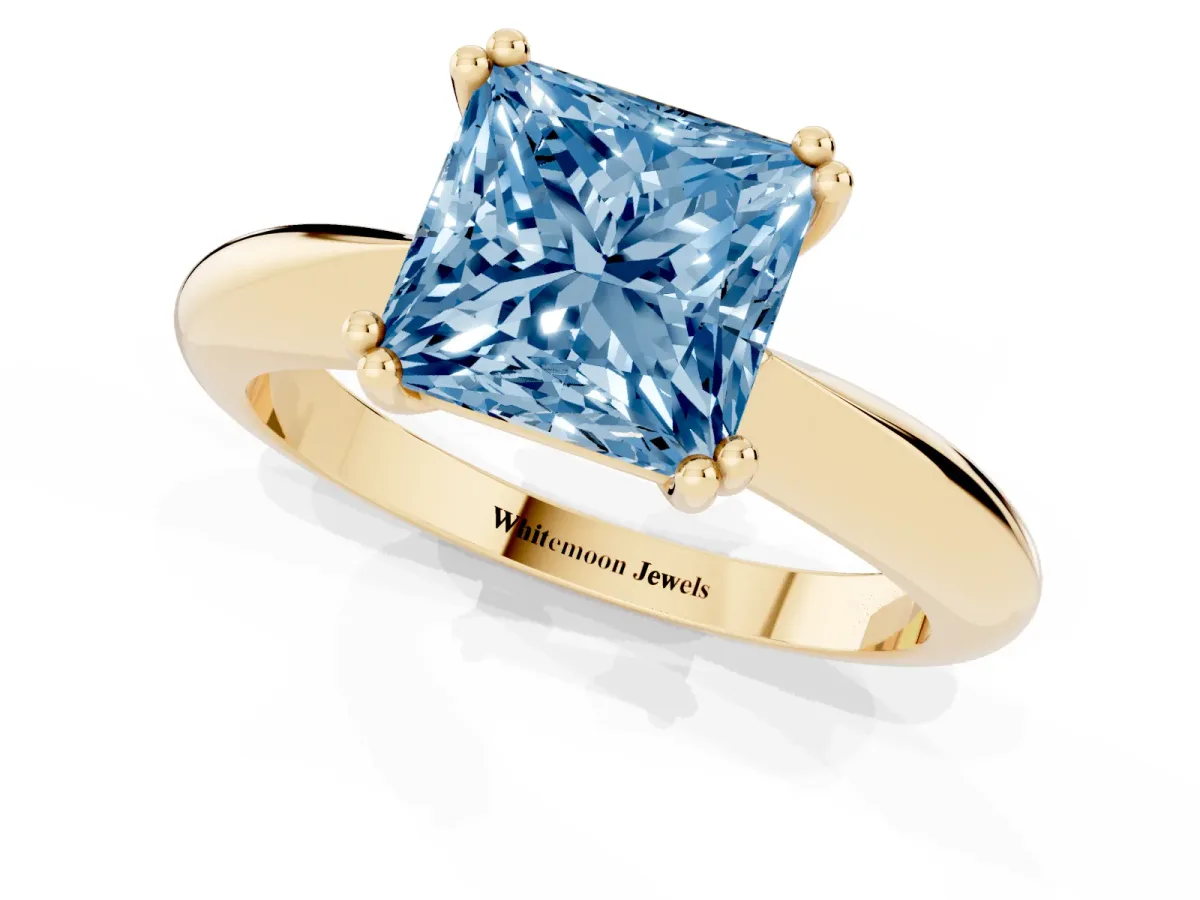 Fancy Blue Princess Cut Cut Solitaire Engagement Ring with Tapered Band and Four-Prong Setting Yellow gold