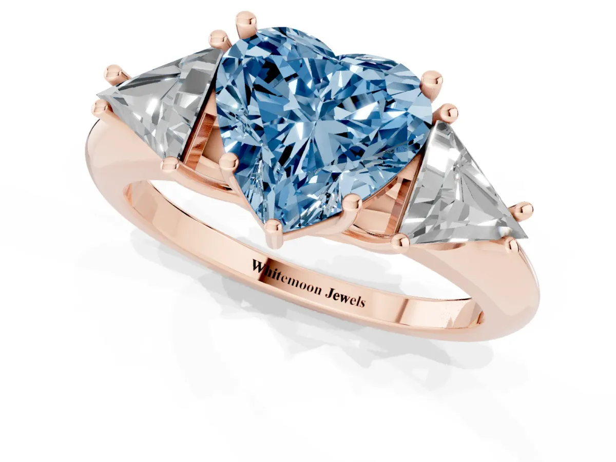 Fancy Blue Three-Stone Heart Cut Diamond Engagement Ring with Trillion Side Stones and Prong Setting Rose gold