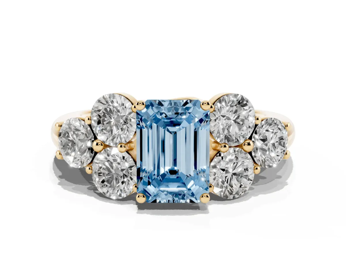 Fancy Blue Emerald Cut Cut Diamond Cluster Ring with Round Accent Stones and Prong Setting on a Classic Band Yellow gold