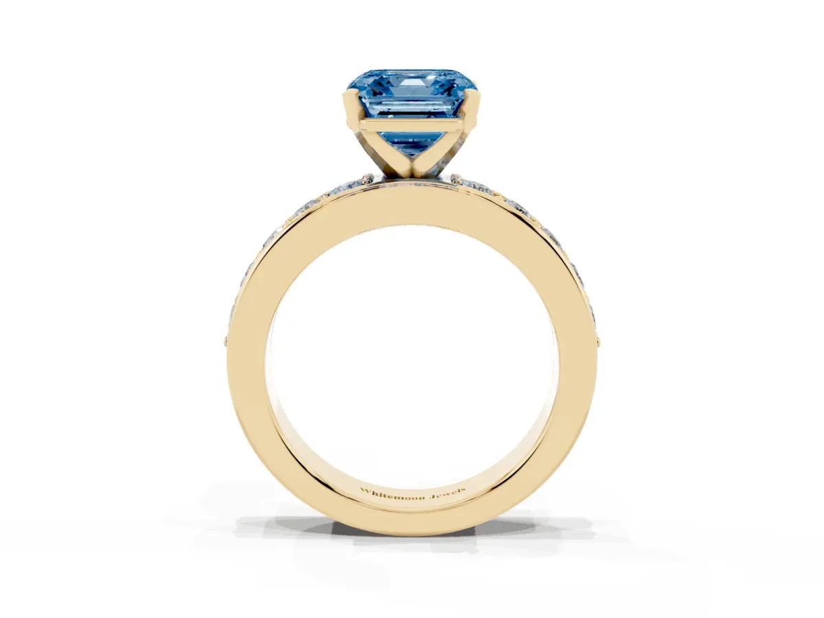 Fancy Blue Asscher Cut Diamond Engagement Ring with Channel Set Round Band and Prong Setting Yellow gold