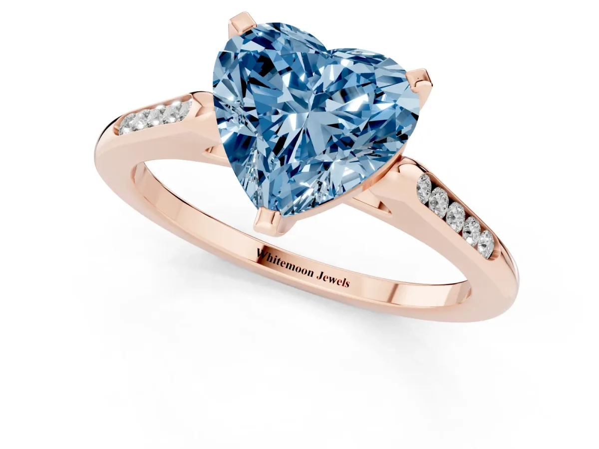 Fancy Blue Heart Cut Diamond Solitaire Ring with Channel Set Round Band and Prong Setting Rose gold