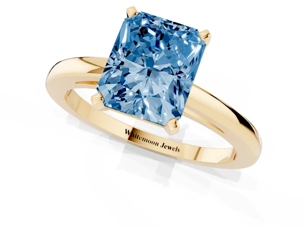 Fancy Blue Radiant Cut Solitaire Diamond Engagement Ring with Four-Prong Setting on a Classic Band Yellow gold