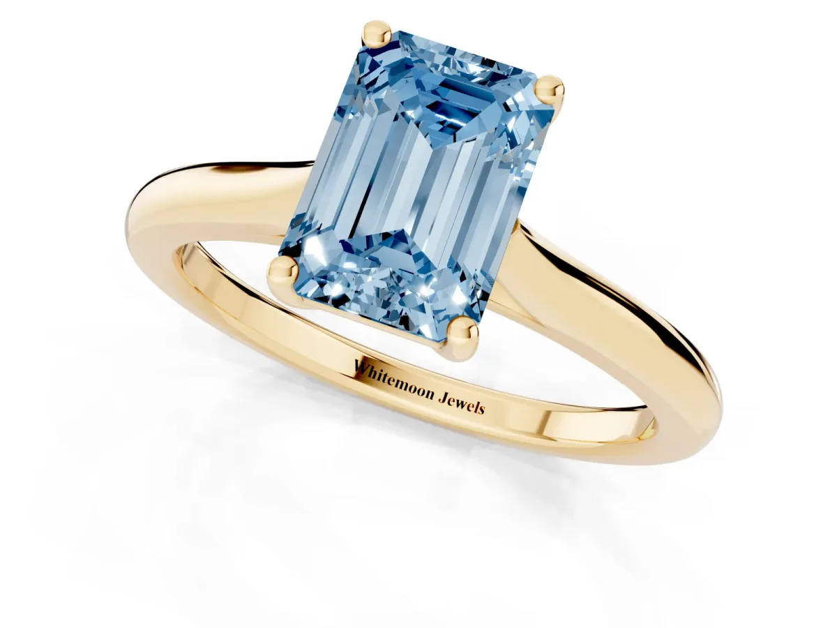 Fancy Blue Emerald Cut Cut Solitaire Ring with Cathedral Band and Four-Prong Setting Yellow gold