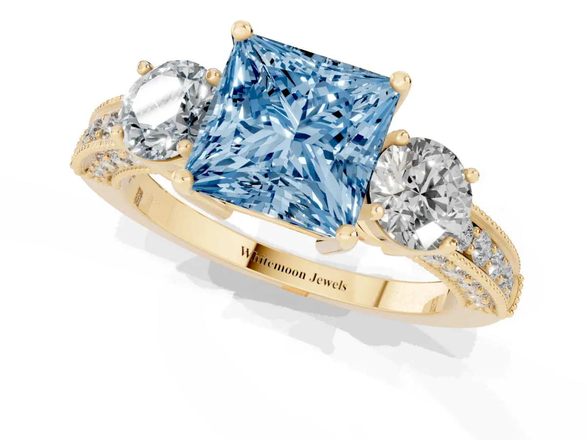 Fancy Blue Princess Cut Three-Stone Diamond Ring with Pavé Band and Four-Prong Setting Yellow gold