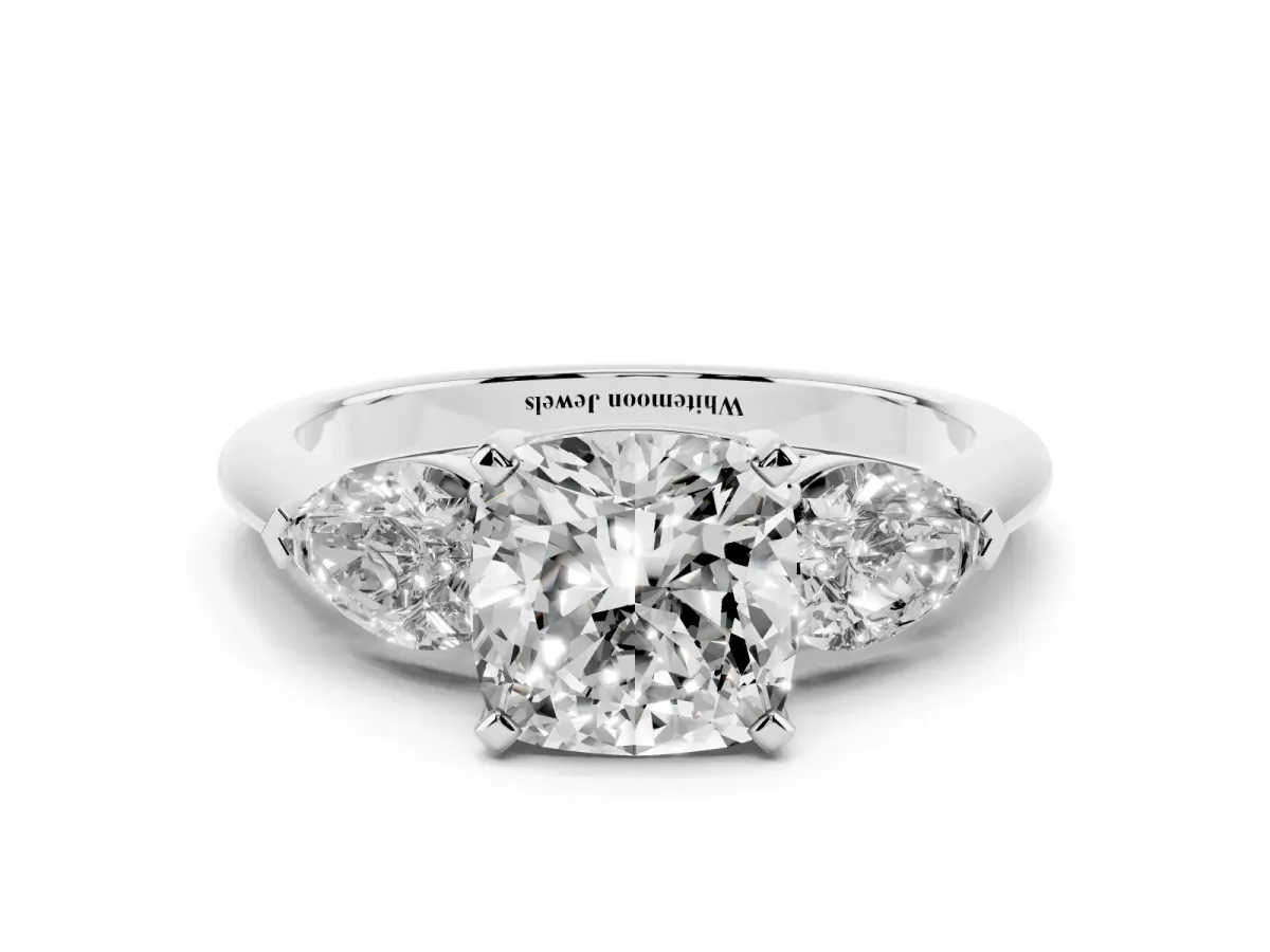 Three-Stone Cushion Cut Diamond Ring with Pear Side Stones and Four-Prong Setting Platinum