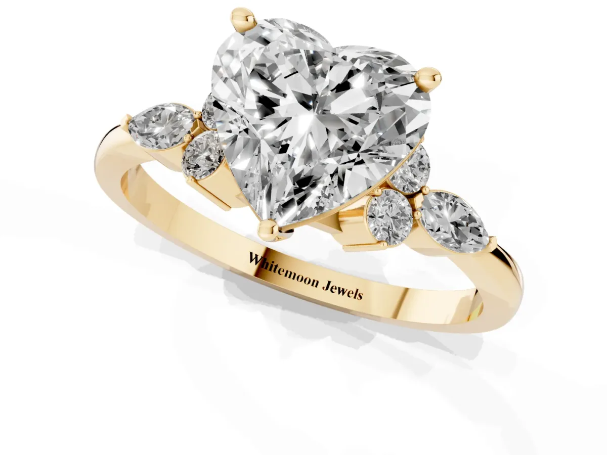 Heart Cut Brilliant Diamond Solitaire Ring with Pear Side Stones and Four-Prong Setting Yellow gold