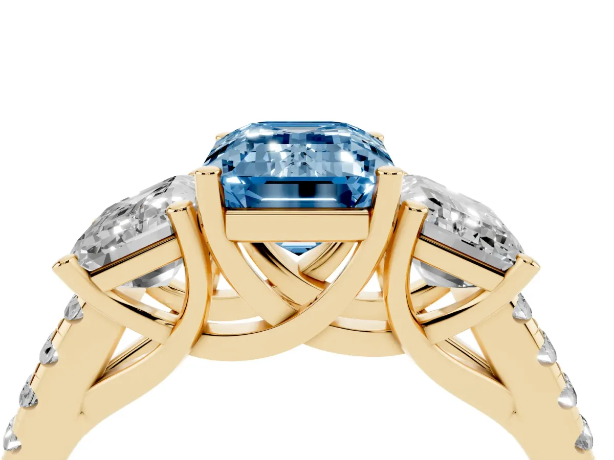 Fancy Blue Three-Stone Emerald Cut Diamond Ring with Round Pavé Band and Prong Setting Yellow gold