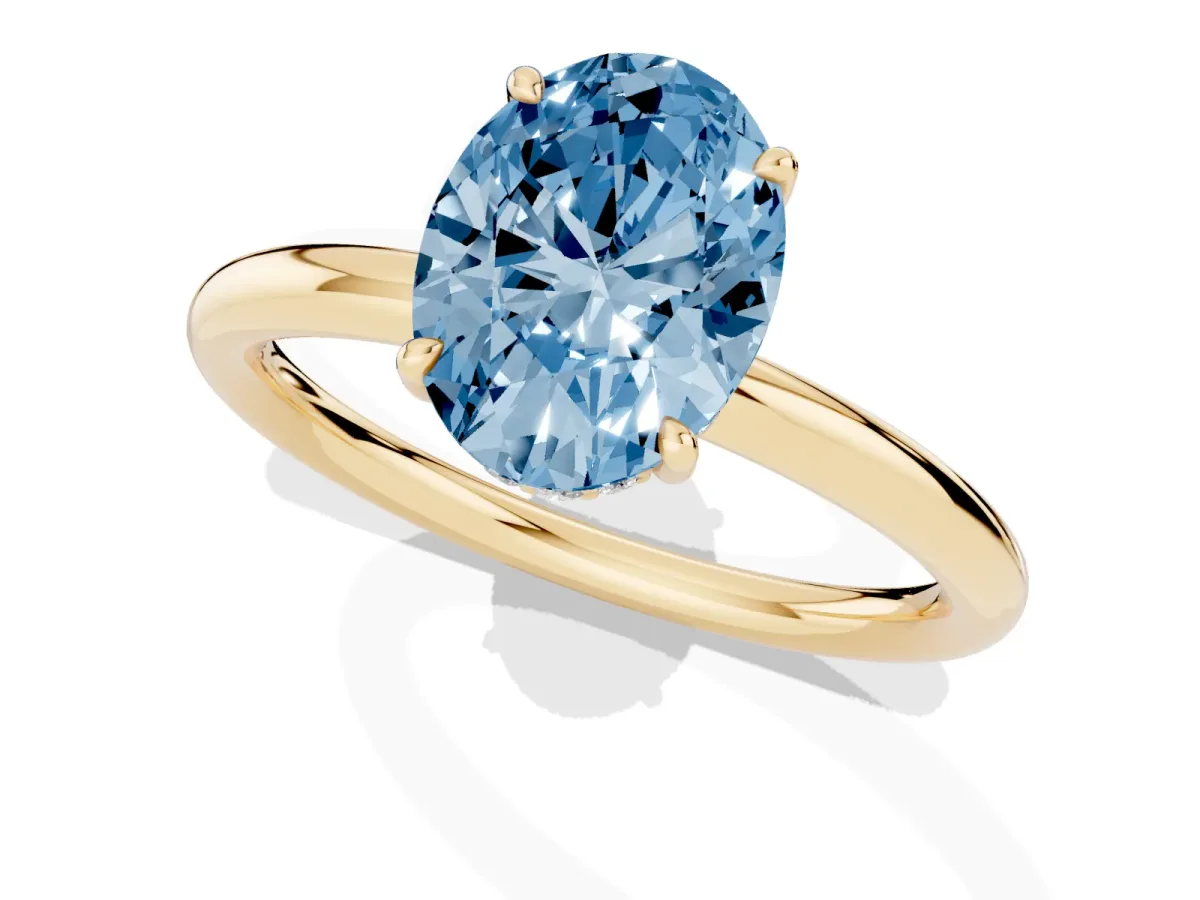 Fancy Blue Oval Cut Diamond Solitaire Ring with Thin Band and Four-Prong Setting Yellow gold