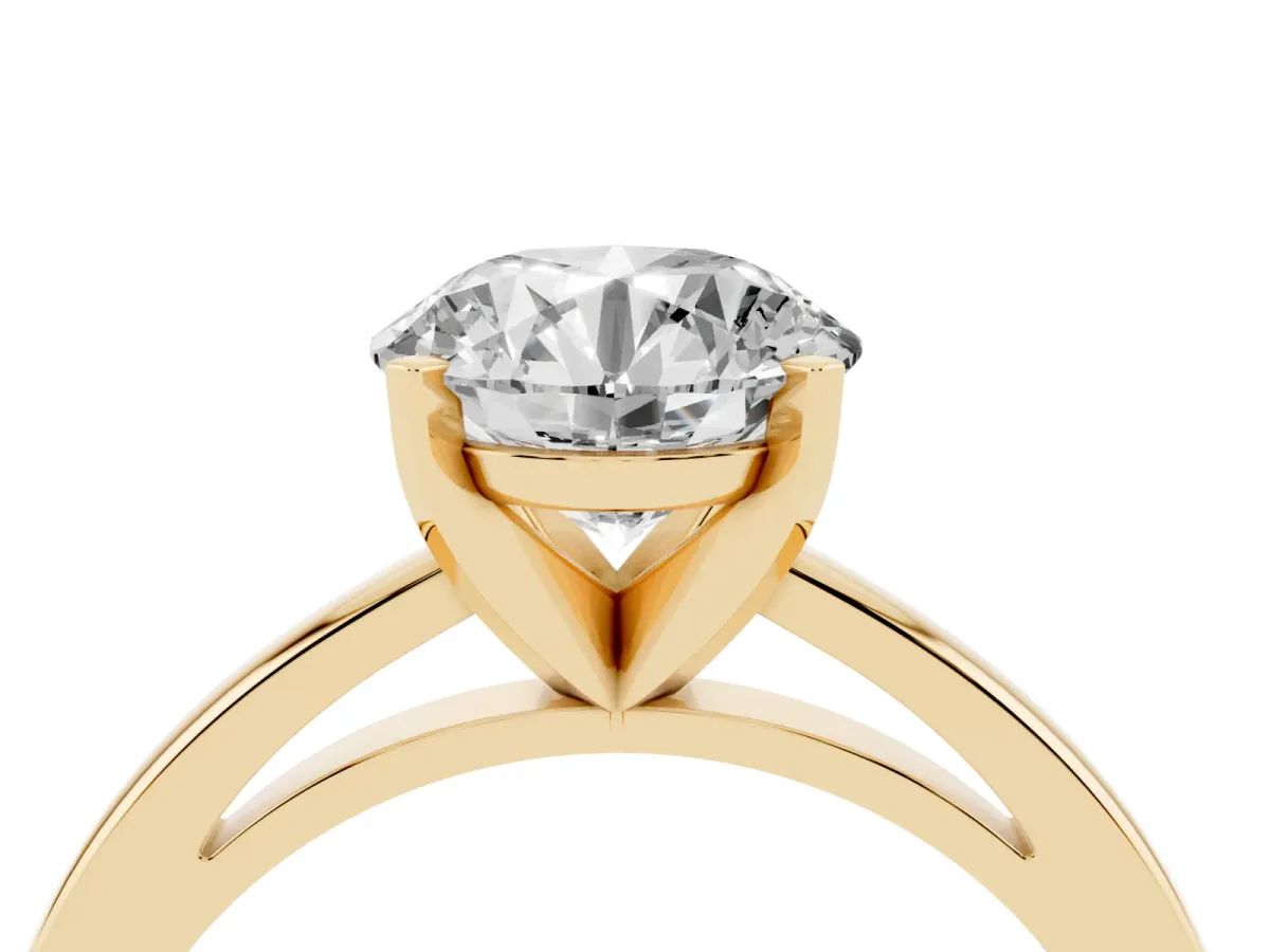 Round Cut Solitaire Diamond Engagement Ring with Four-Prong Setting on a Classic Band Yellow gold