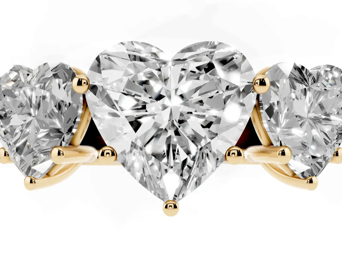 Heart Cut Three-Stone Diamond Ring with Prong Setting on a Classic Band Yellow gold