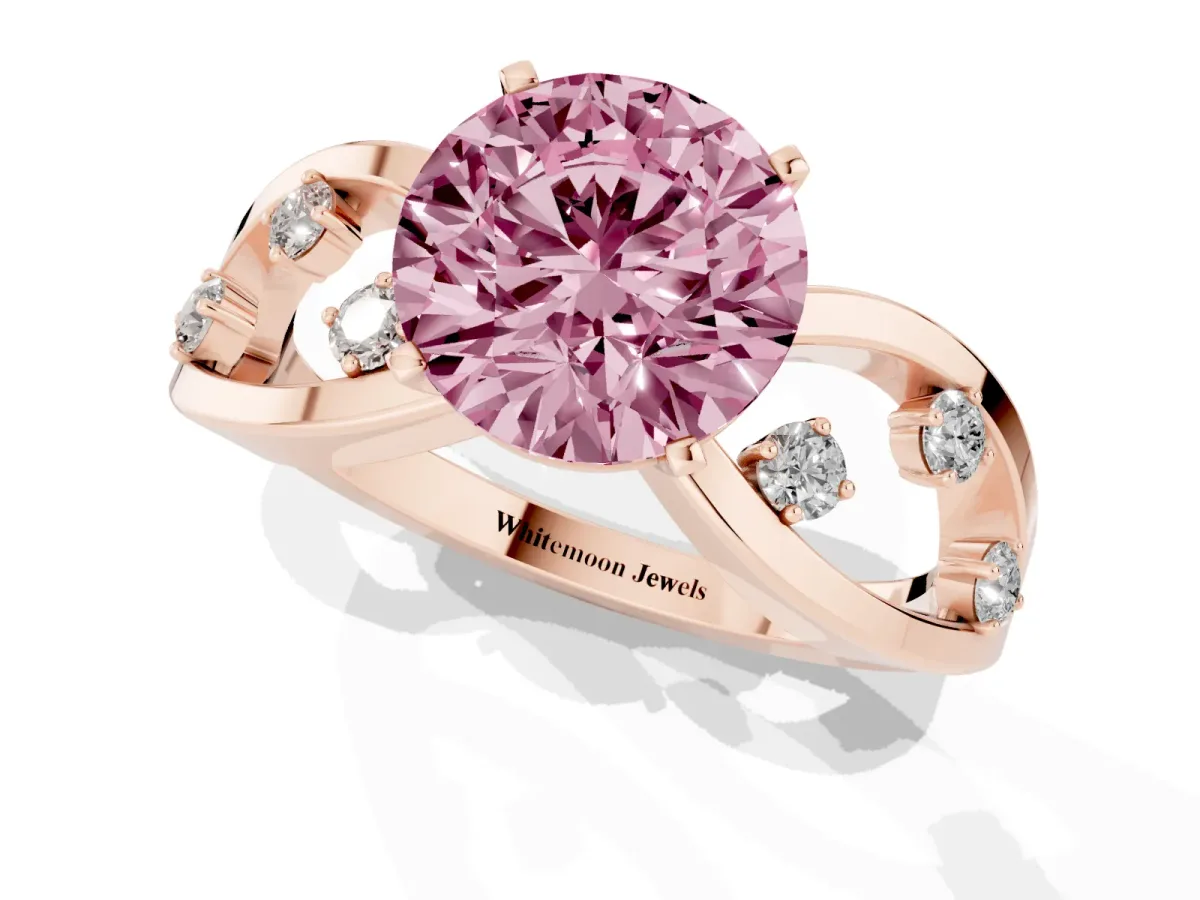 Fancy Pink Round Cut Cut Solitaire Diamond with Side Stones on Criss-Cross Band and Four-Prong Setting Rose gold
