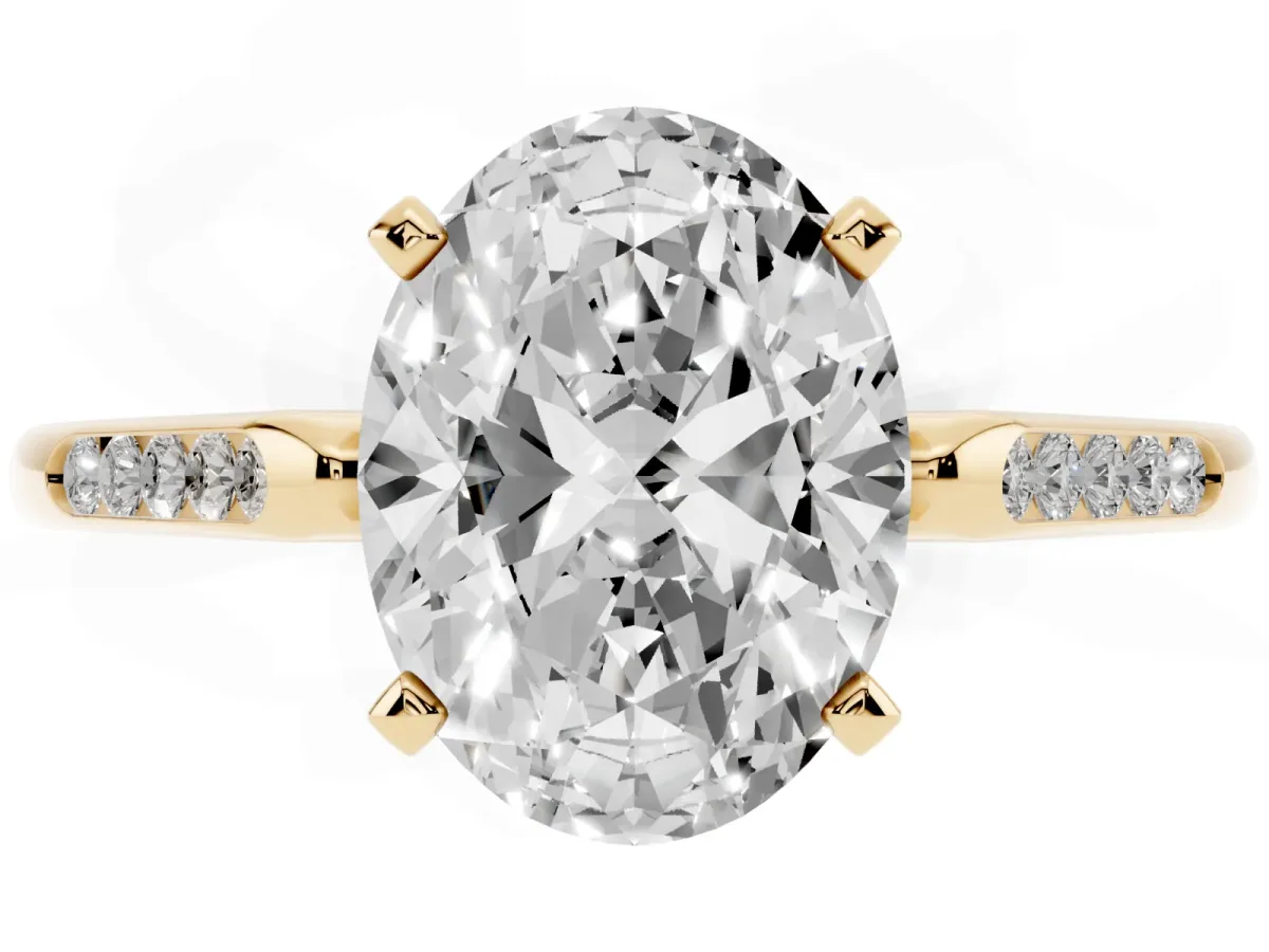 Oval Cut Diamond Solitaire Ring with Channel Set Round Band and Prong Setting Yellow gold