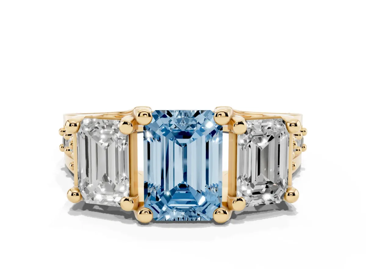 Fancy Blue Emerald Cut Diamond Three-Stone Ring with Channel Set Band and Four-Prong Setting Yellow gold