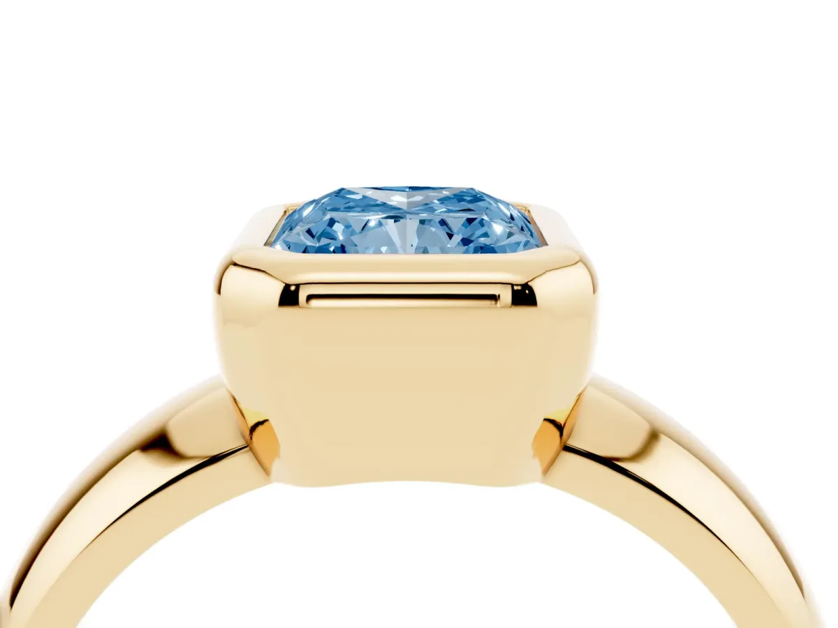 Fancy Blue Bezel Set Radiant Cut Solitaire Ring with Wide Band Yellow gold