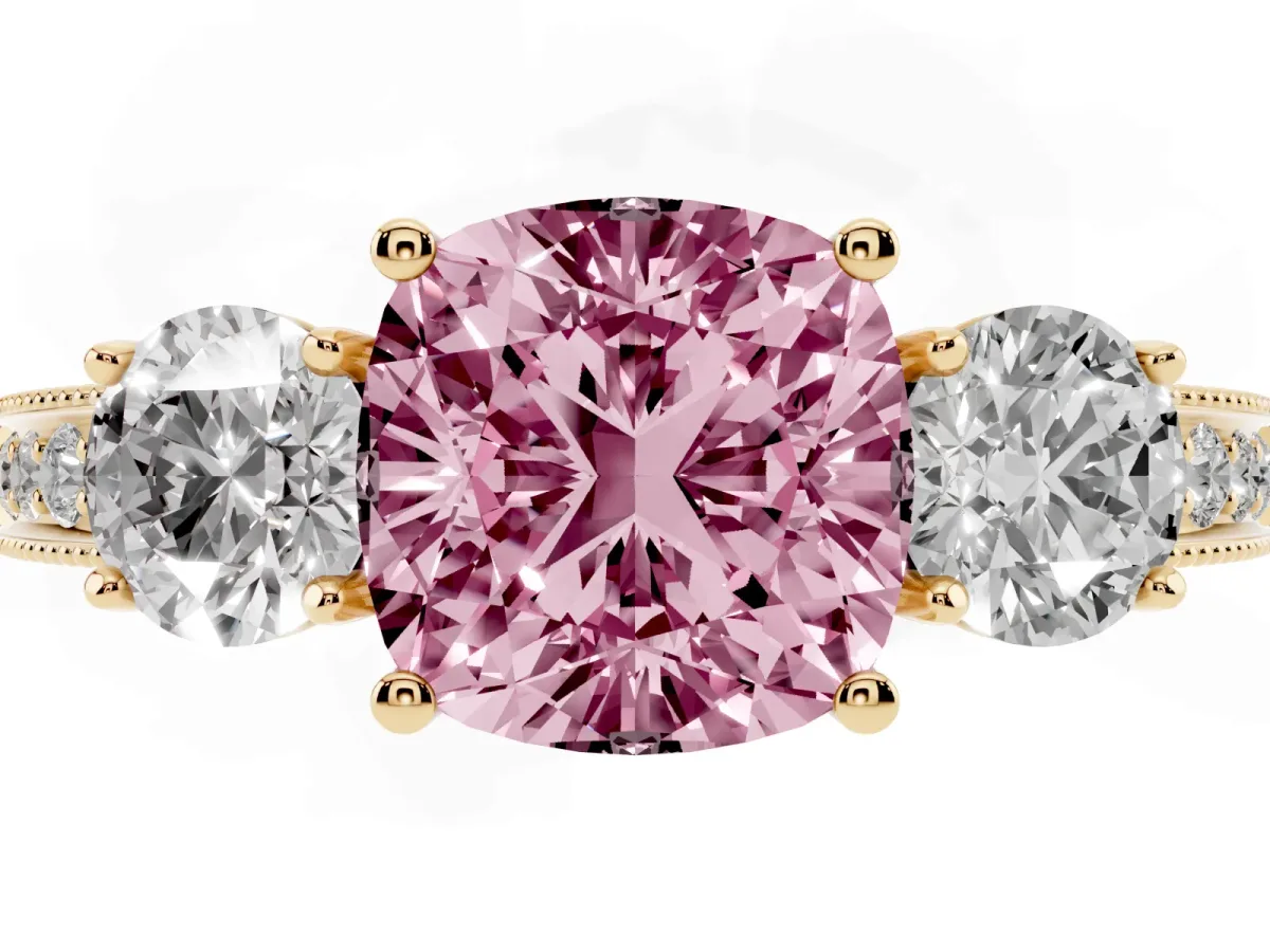 Fancy Pink Cushion Cut Three-Stone Diamond Ring with Pavé Band and Four-Prong Setting Yellow gold
