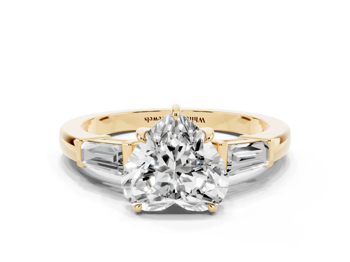 Heart Cut Diamond Three-Stone Ring with Tapered Baguette Side Stones and Prong Setting Yellow gold
