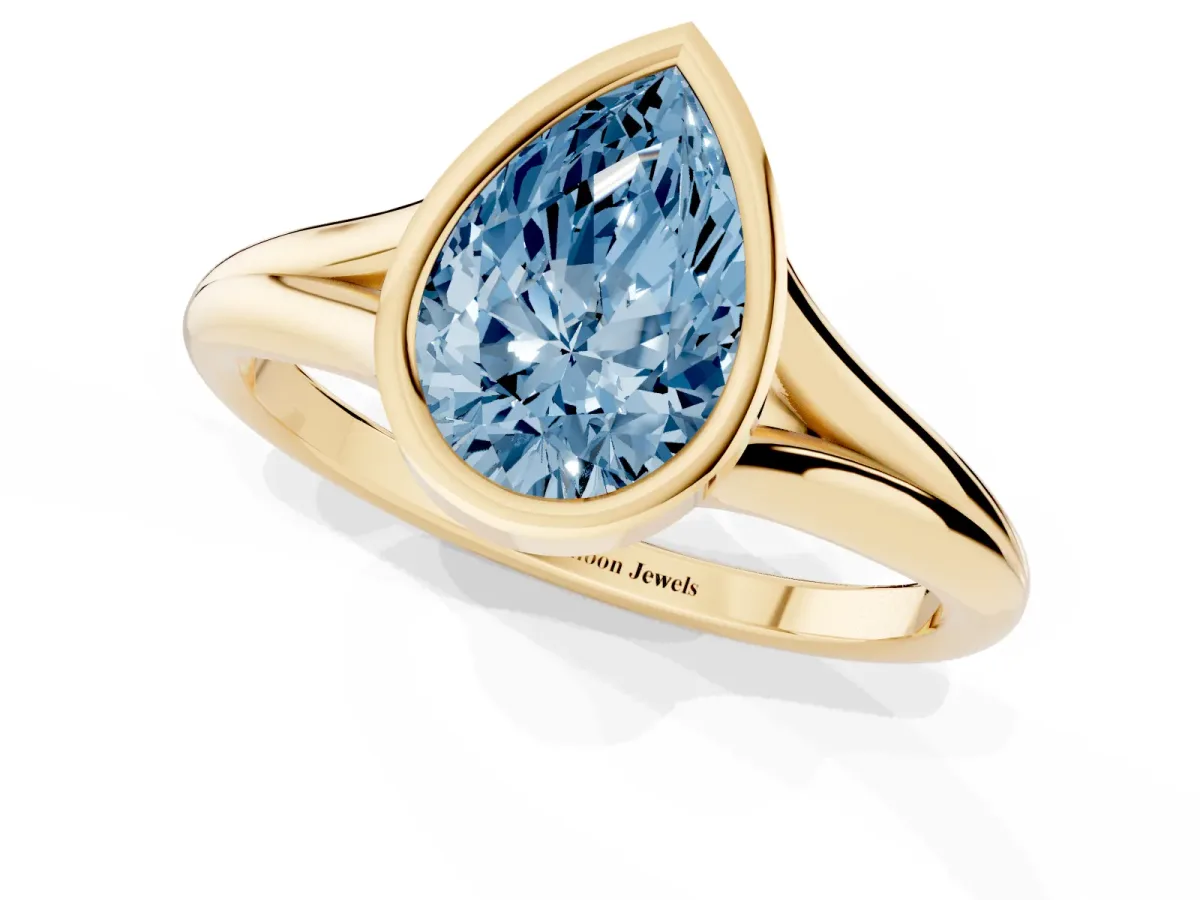 Fancy Blue Bezel Set Pear Cut Cut Solitaire Ring with Tapered Band Yellow gold