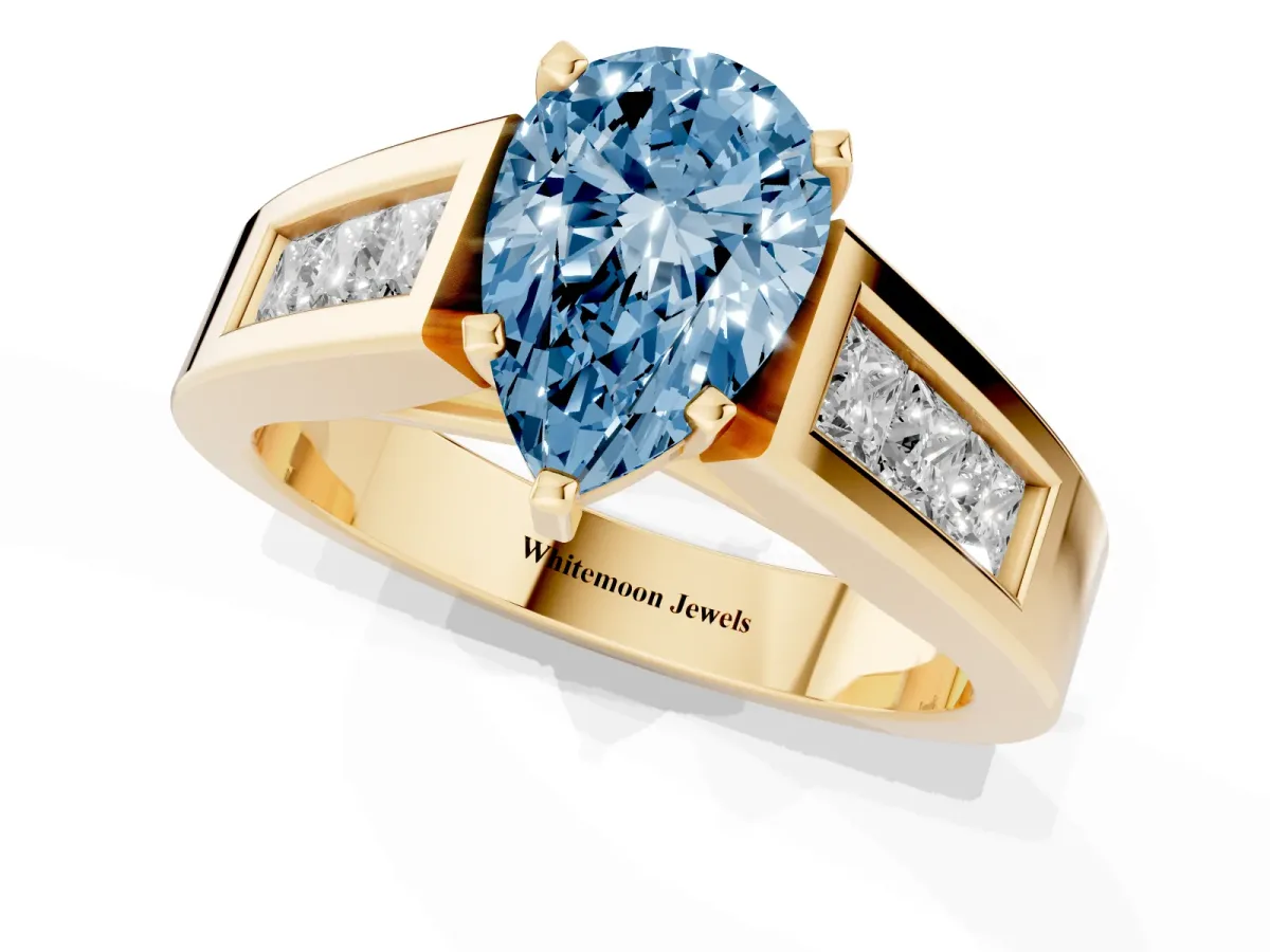 Fancy Blue Pear Cut Cut Channel Set Solitaire Ring with Four-Prong Setting Yellow gold