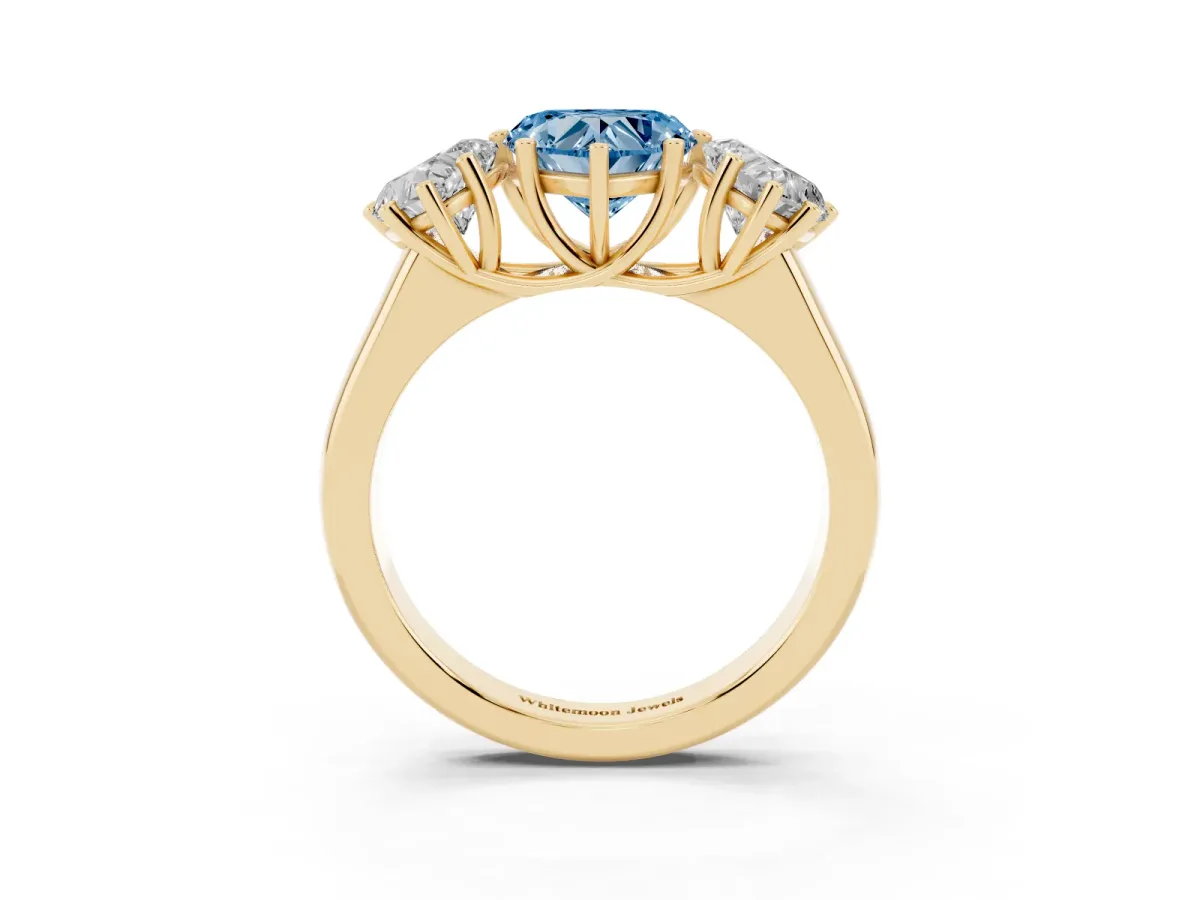 Fancy Blue Heart Cut Three-Stone Diamond Ring with Prong Setting on a Classic Band Yellow gold