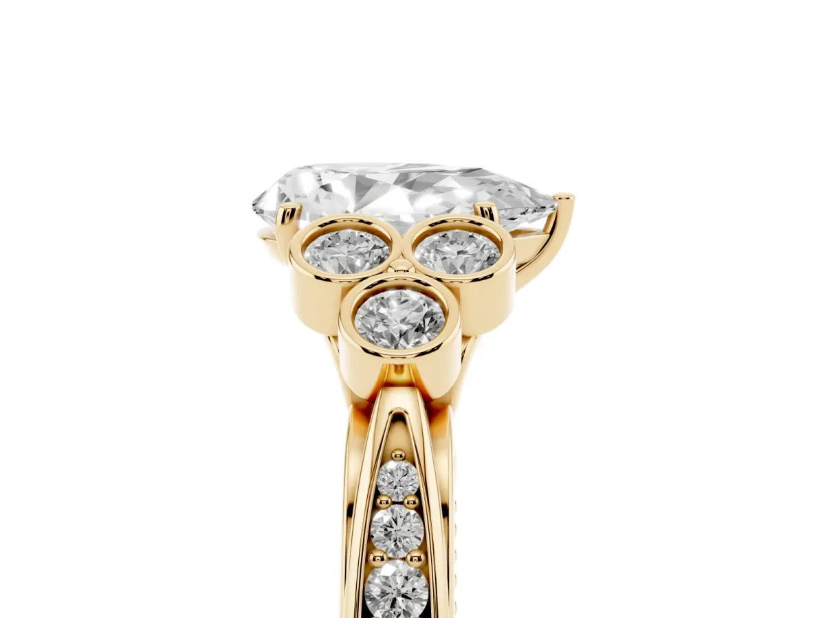 Pear Cut Cut Diamond Engagement Ring with Bezel Set Round Side Stones and Prong Setting Yellow gold