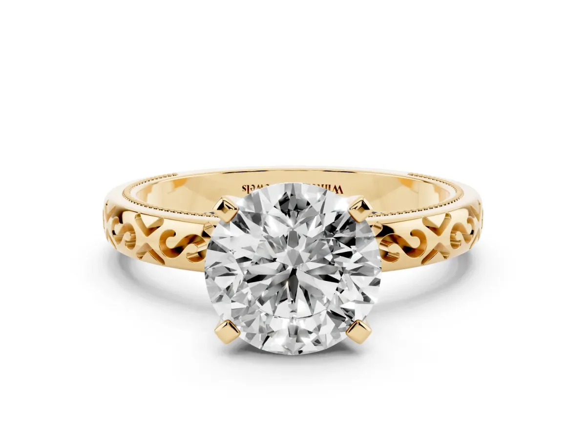 Round Cut Solitaire Engagement Ring with Scrollwork Band and Four-Prong Setting Yellow gold