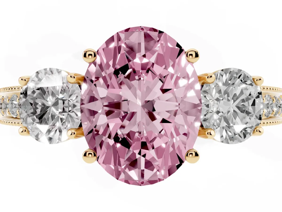 Fancy Pink Oval Cut Three-Stone Diamond Ring with Pavé Band and Four-Prong Setting Yellow gold