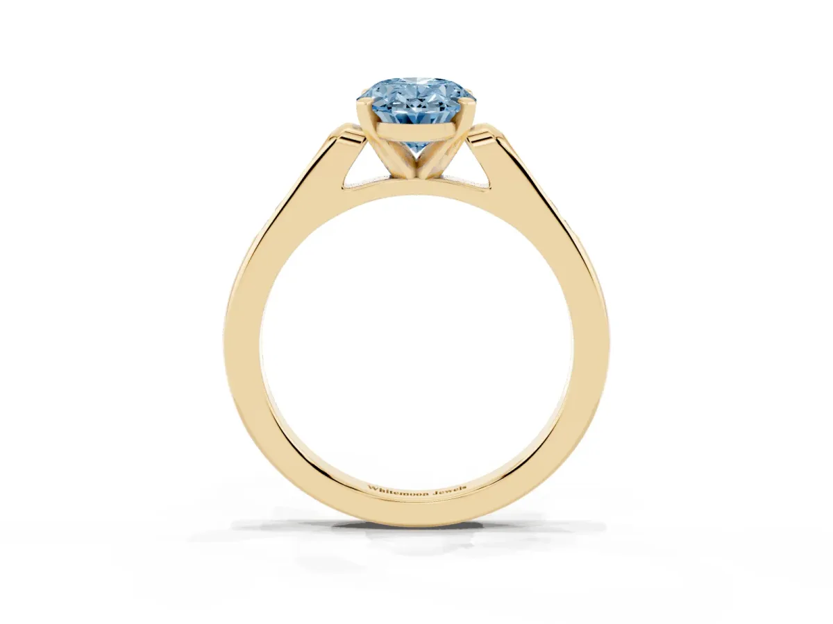 Fancy Blue Oval Cut Diamond Solitaire Ring with Channel Set Round Band and Prong Setting Yellow gold