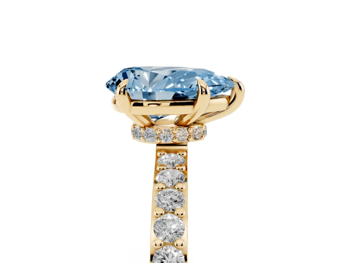 Fancy Blue Pear Cut Diamond Pavé Engagement Ring with Round Accents and Prong Setting Yellow gold