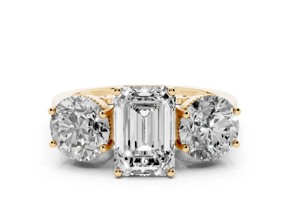 Three-Stone Emerald Cut Diamond Engagement Ring with Prong Setting on a Classic Band Yellow gold