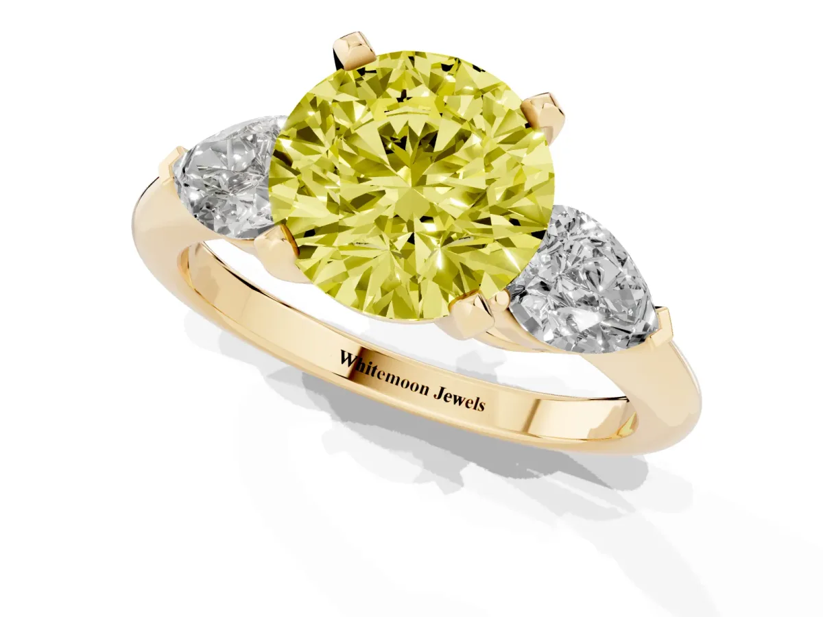 Fancy Yellow Three-Stone Round Cut Diamond Ring with Pear Side Stones and Four-Prong Setting Yellow gold